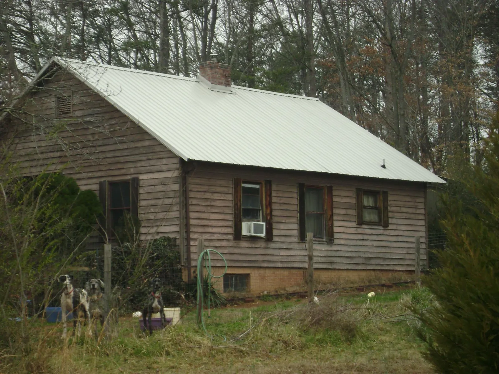 White metal roof on an old wood sided farmhouse, from a Asphalt Shingle Roof Repair job in Bessemer City